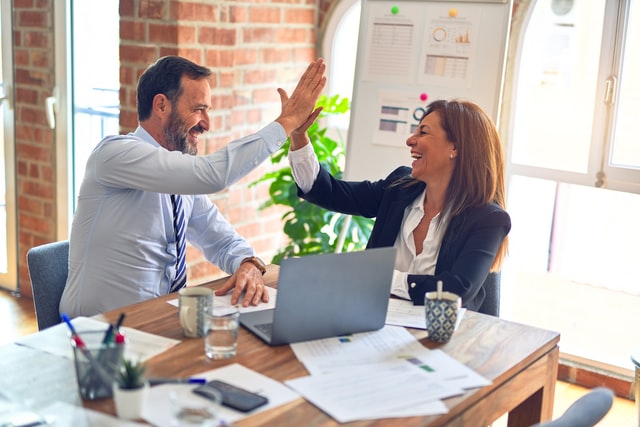 coworkers having a high five